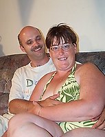 Mature couple having sex on their scruffy couch