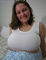 Big titted mature babe playing with her body
