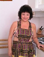 Fat housewife posing naked in the kitchen